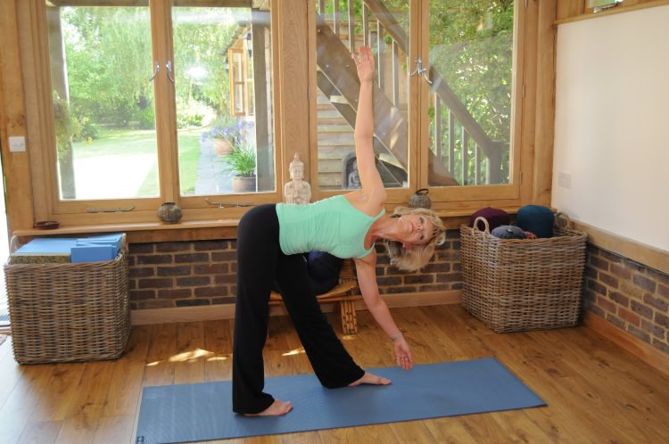 Sarah Church practising Yoga in Guildford inside Studio.